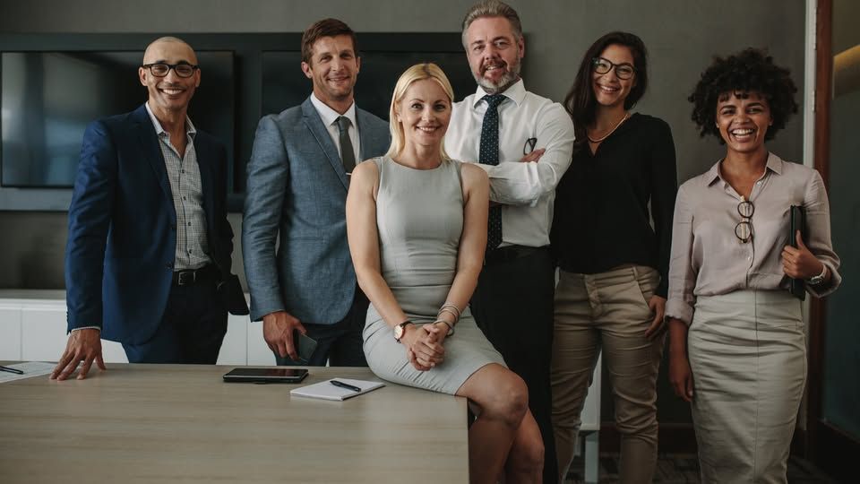 Photo of diverse professionals smiling at the camera