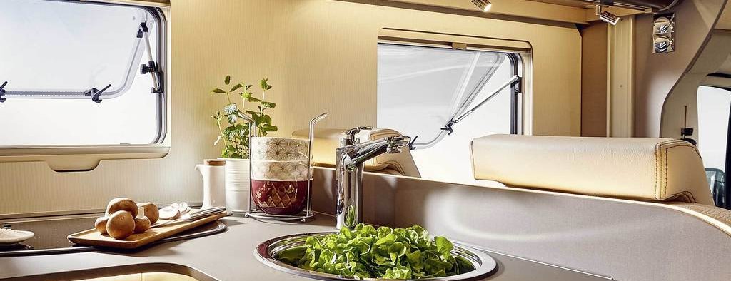 Campervan parked near a loch, ready for adventure. DIY plumbing project symbolises freedom and self-sufficiency.