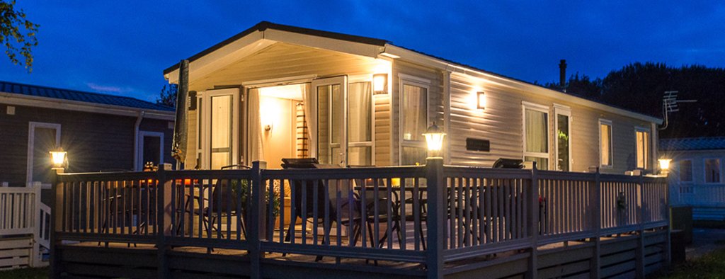 Caravan parked at a sunny holiday park, representing the costs of owning a static caravan.