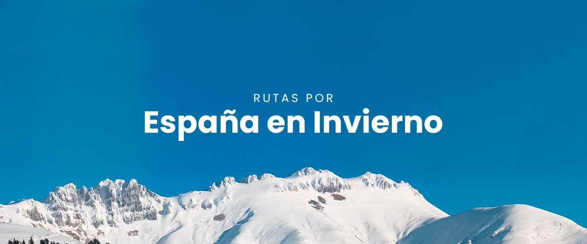 Autocaravana en la nieve con montañas al fondo. Vacaciones de invierno en España.