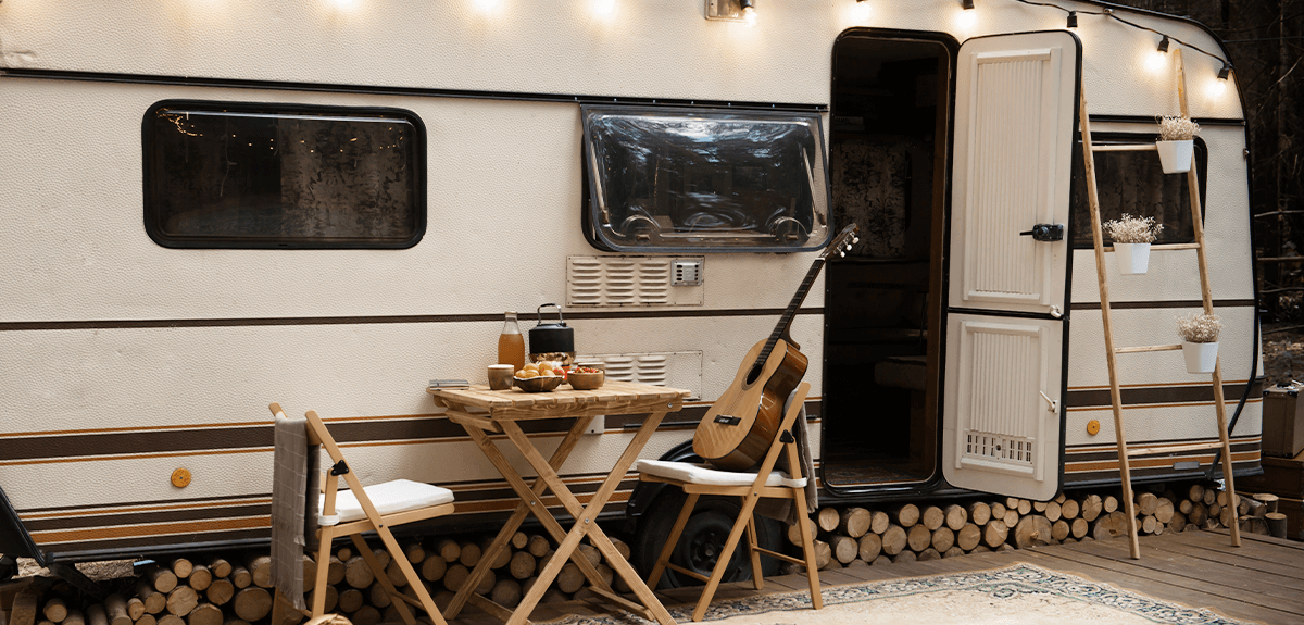 Caravan parked at a sunny campsite, ready for holidaymakers. Earn money from hiring out your caravan.