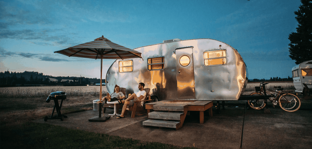 Caravan parked on a grassy campsite, ready for a family holiday.