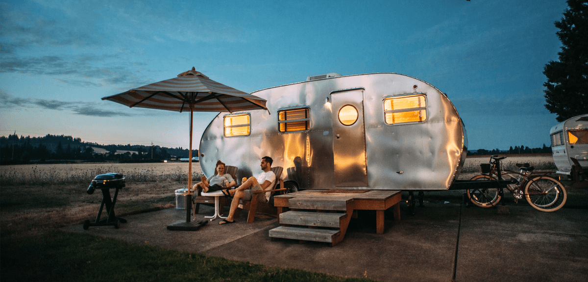 Caravan parked on a grassy campsite, ready for a family holiday.