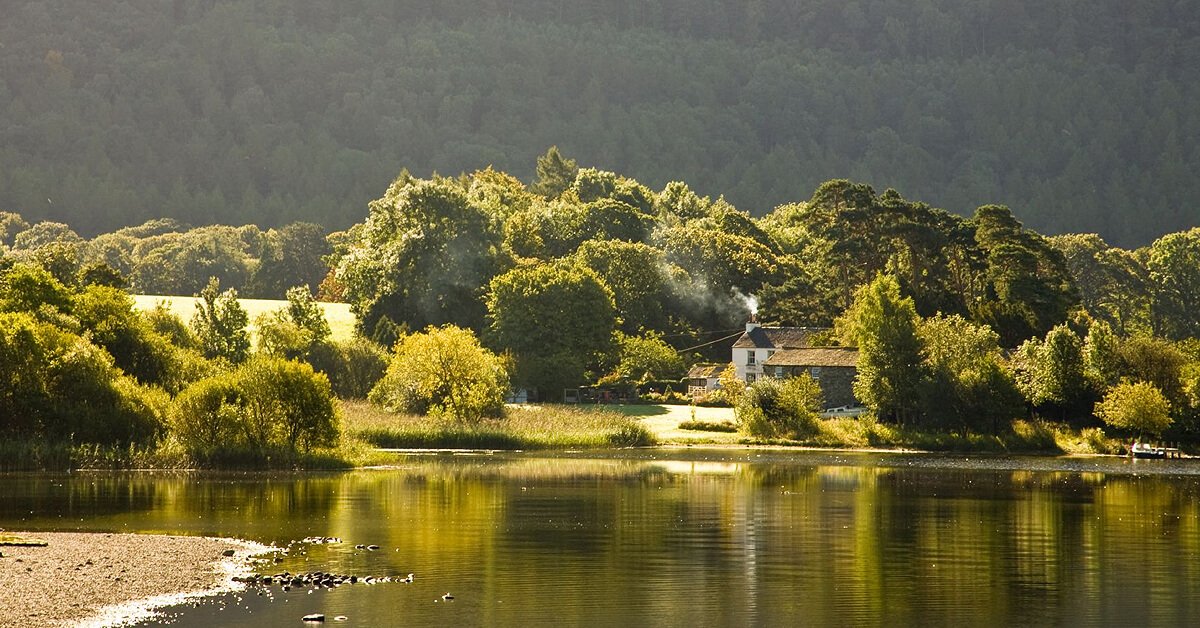 Family hiking near a scenic lake in the Lake District; unforgettable holiday adventures.