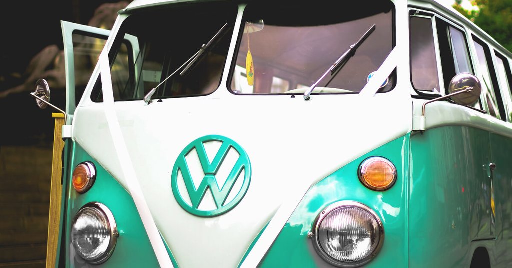 Campervan parked on a cliff top overlooking the sea, UK road trip.
