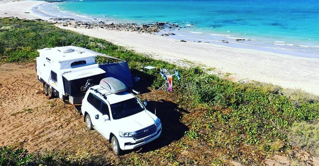 Family caravanning holiday at a beachside caravan park with kids playing.