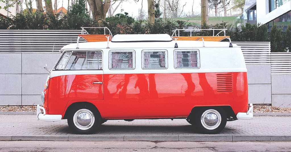 Campervan parked on a clifftop overlooking the sea, ready for a UK camping adventure.