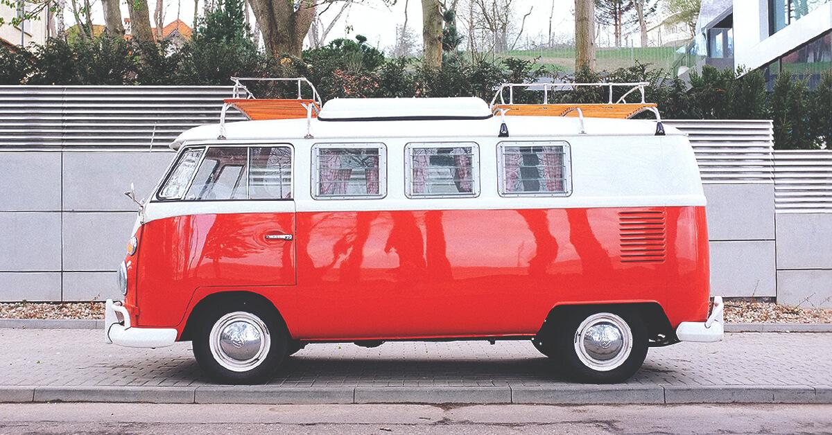 Campervan parked on a clifftop overlooking the sea, ready for a UK camping adventure.
