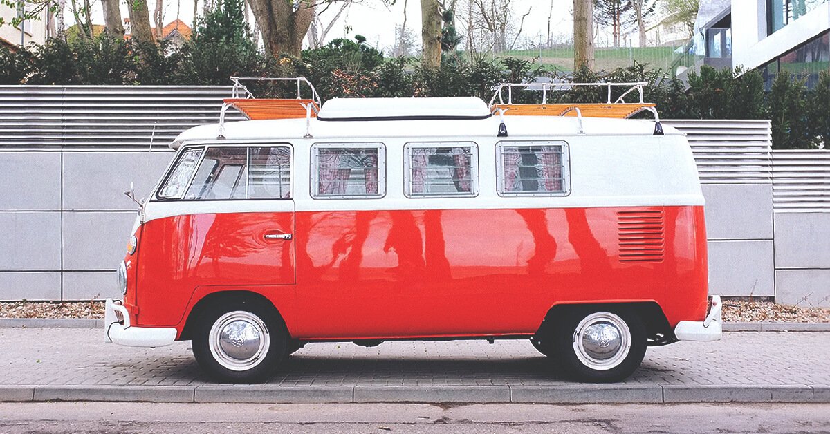 Campervan parked on a clifftop overlooking the sea, ready for a UK camping adventure.