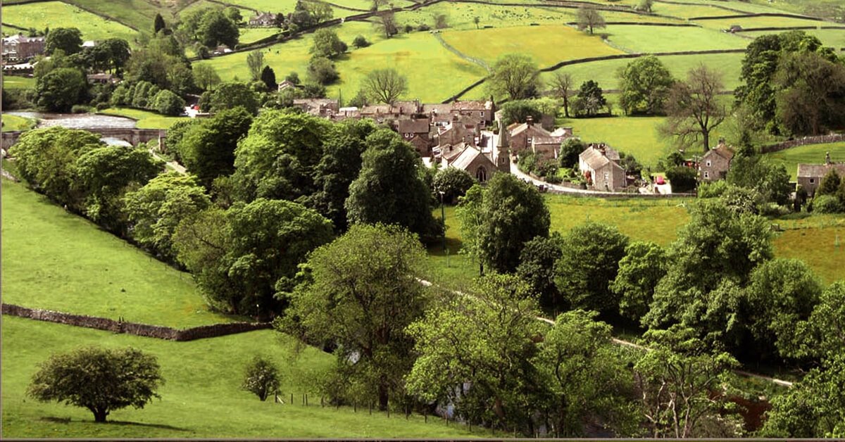 Family hiking near ruined castle in the Yorkshire Dales.