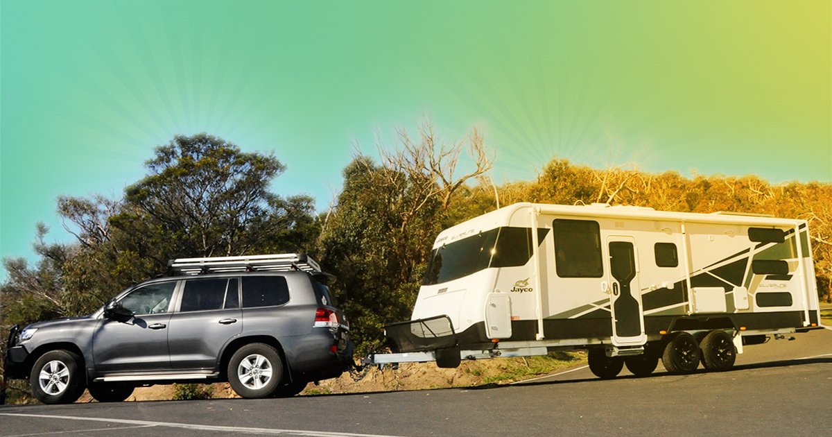 Caravan rolling down a red dirt road, blue sky, typical Aussie outback adventure.