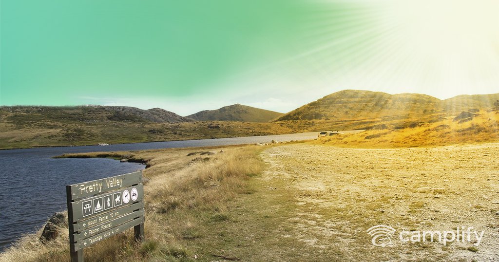 Tents pitched amongst gum trees in an Aussie national park camping ground.