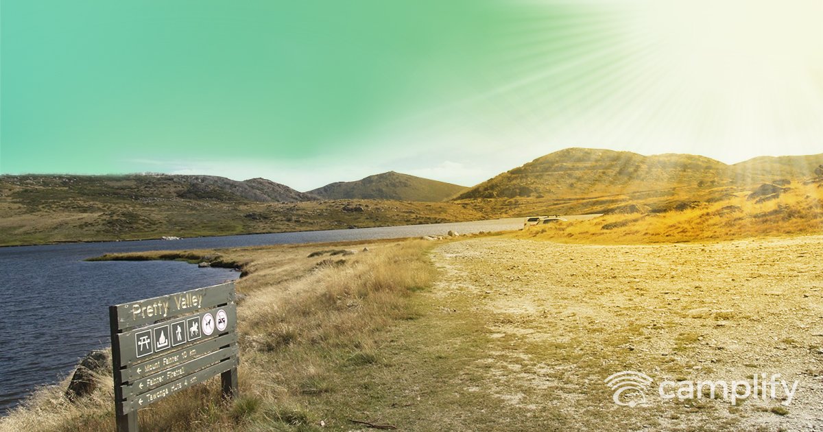 Tents pitched amongst gum trees in an Aussie national park camping ground.