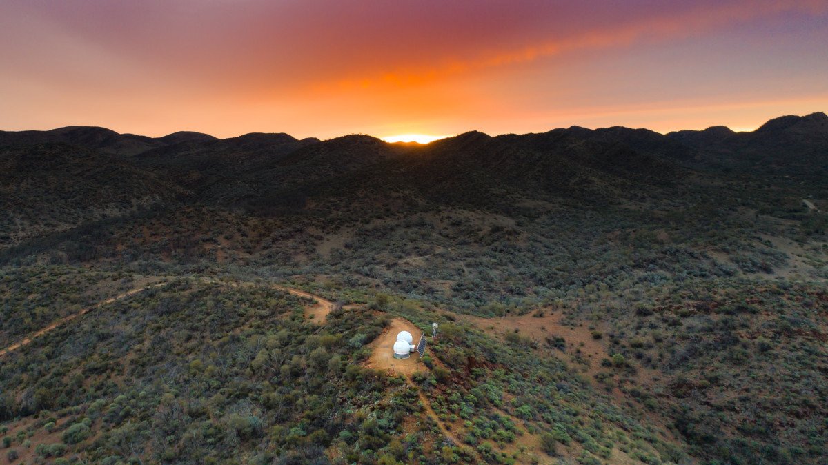Camping in the Flinders Ranges. A four-wheel drive is parked near a tent under a starry outback sky.