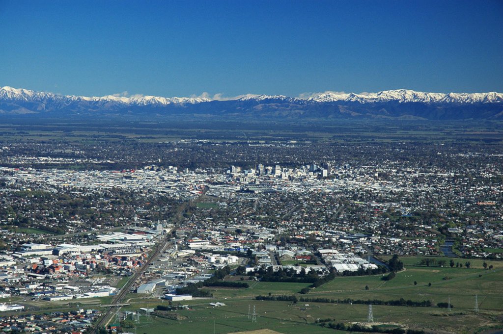 Campervan parked at a campground, Southern Alps in the background. Perfect for a South Island getaway.