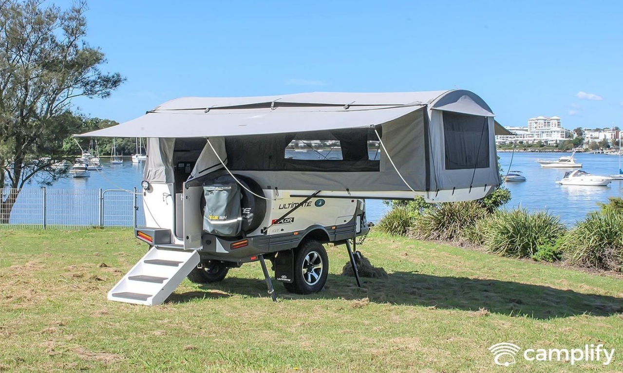 Camper trailer setup at a bush campsite in the Aussie outback, ready for adventure.