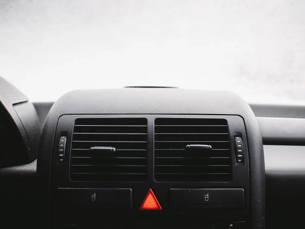 Campervan parked on a campsite, condensation steaming from the windows on a frosty morning.
