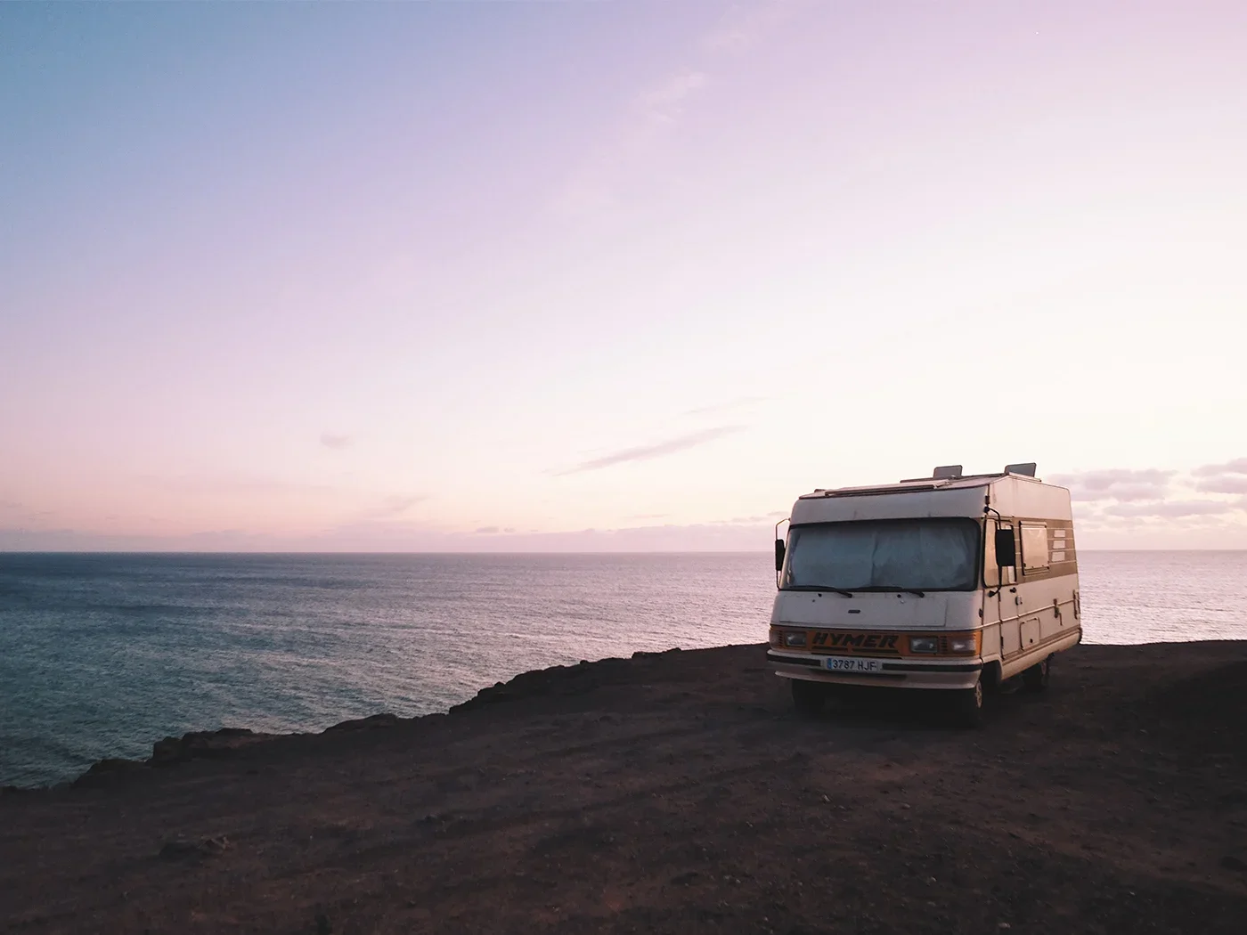 Campervan parked overlooking a scenic loch, ready for a cosy camping adventure.