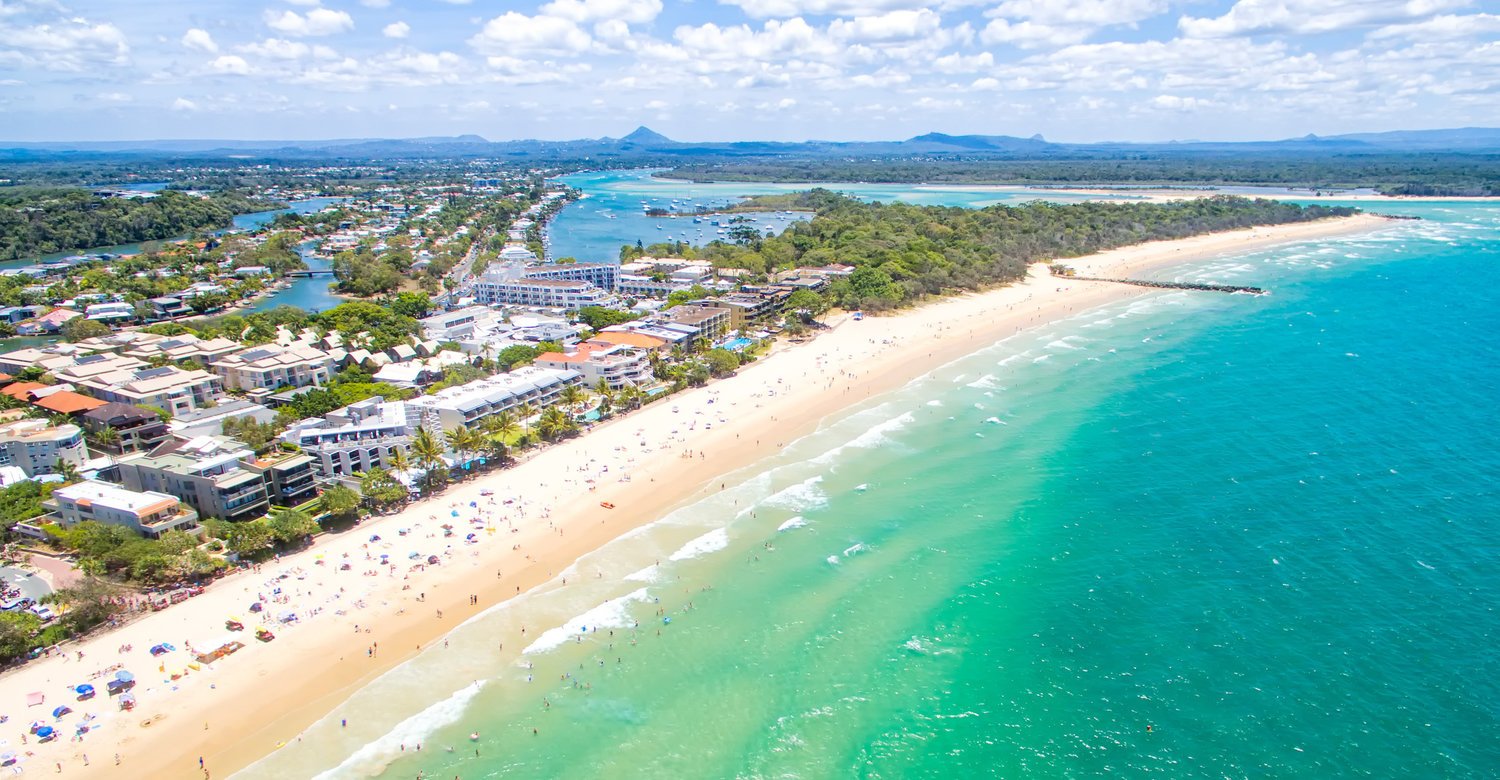 Noosa beach scene with turquoise water, perfect for a summer holiday in Queensland.