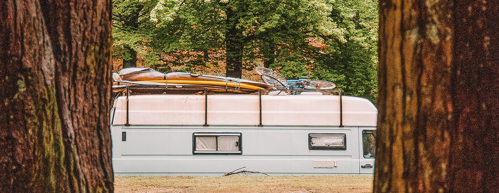 Campervan parked amongst golden autumn trees, South West England adventure.