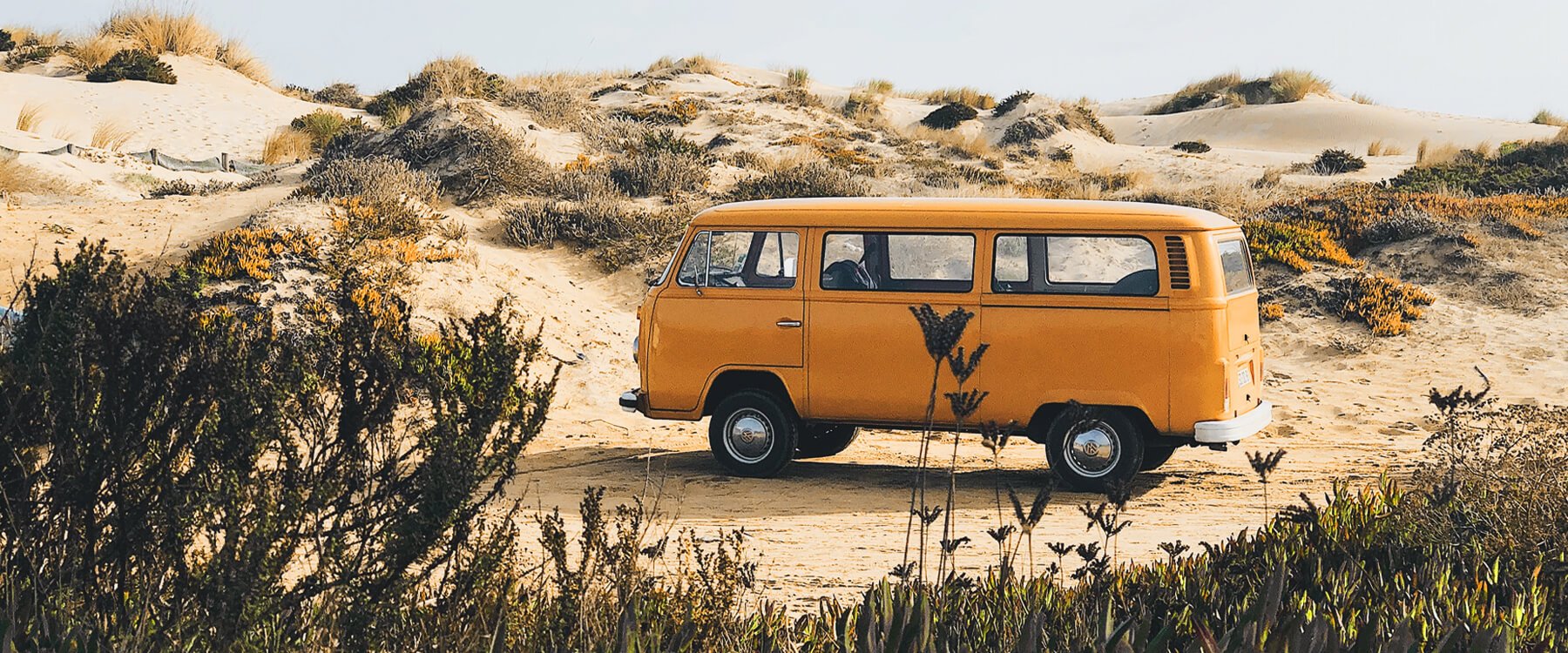 Campervan parked on a clifftop overlooking the sea, family enjoying a road trip.
