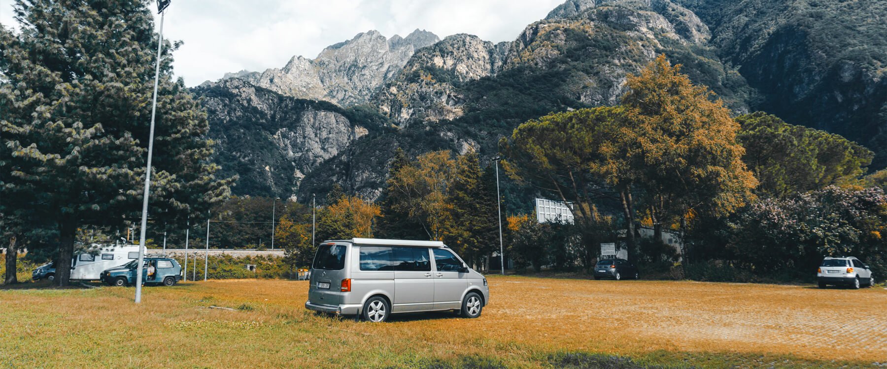 Wild camping gear spread out on a grassy UK hillside, ready for an overnight adventure.