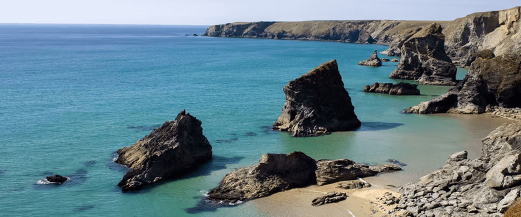 Cornish seaside: family enjoying Easter camping holiday with campervan near the coast.