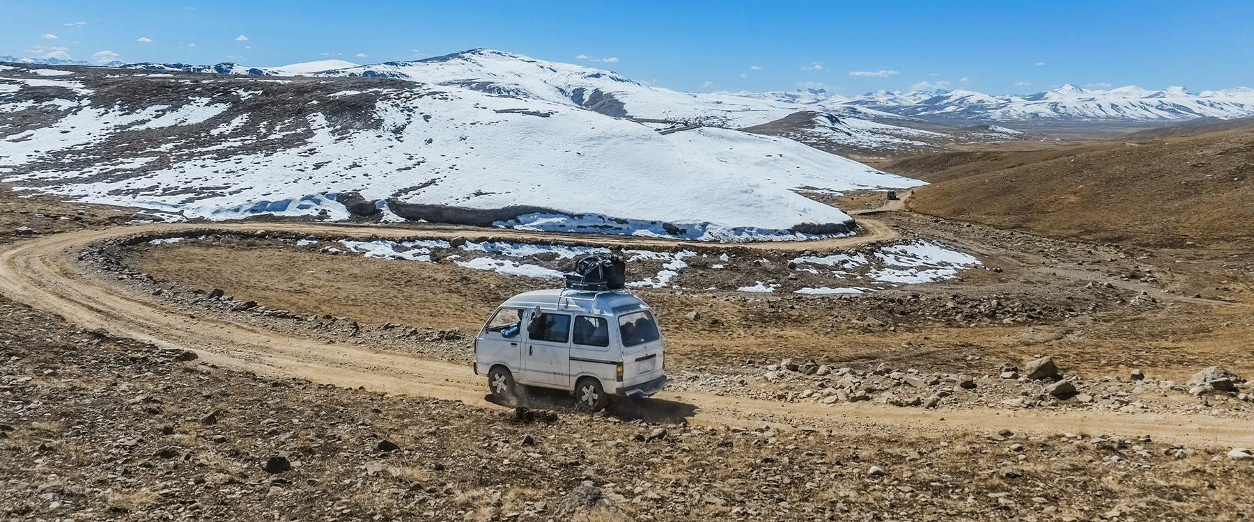 Caravan nestled in a snow-covered campsite, ready for winter.