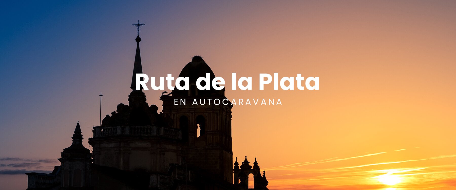 Autocaravana en la Ruta de la Plata con paisaje histórico al fondo. Viaje y turismo en camper.