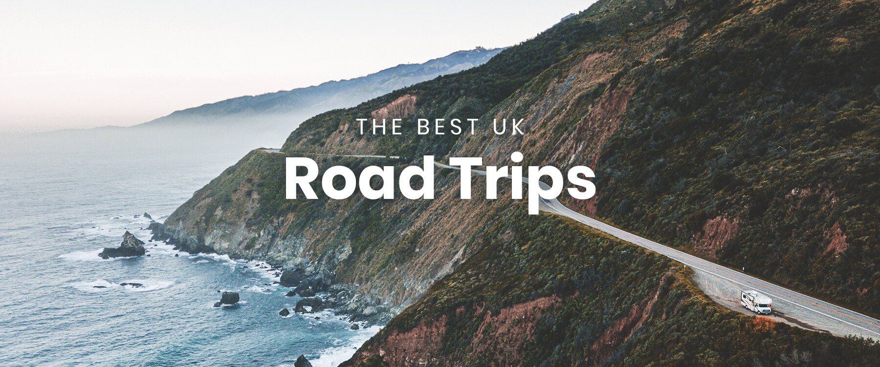 Campervan parked near a scenic loch in the Scottish Highlands, ready for a road trip adventure.