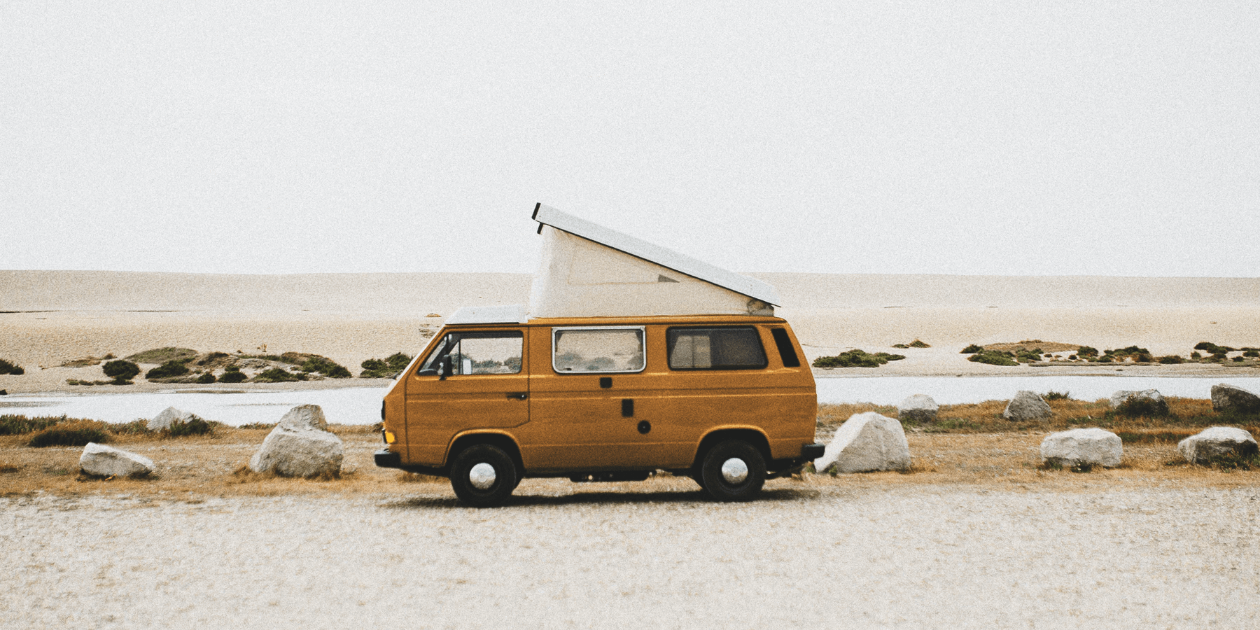 Campervan parked up overlooking scenic coastline. Road trip holiday in the UK.
