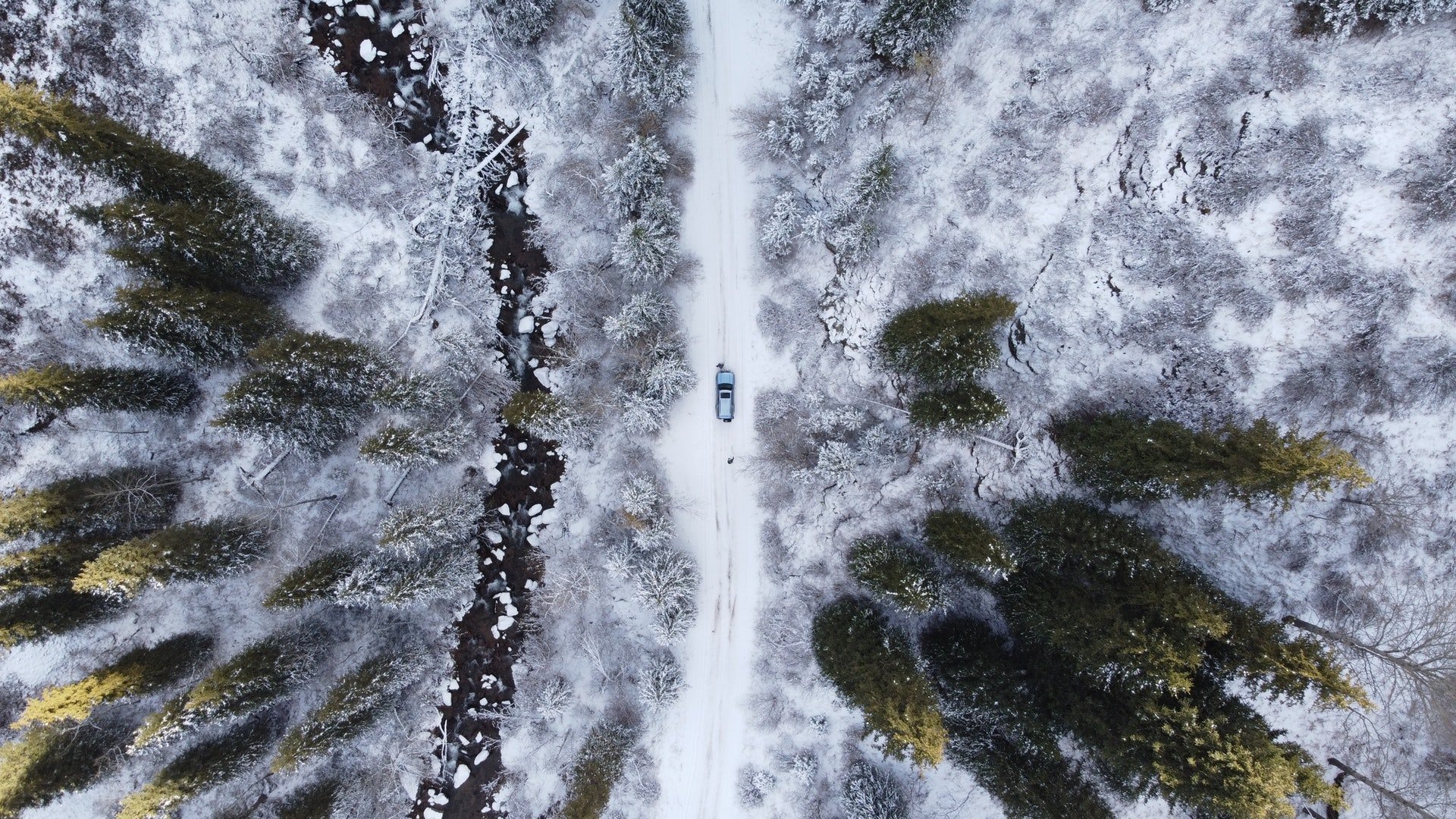 Campervan parked near snow-capped Scottish mountains, ready for a skiing adventure.