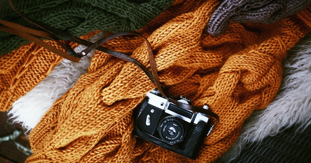Cosy campervan parked near a loch in the Scottish Highlands, ready for an autumn glamping holiday.