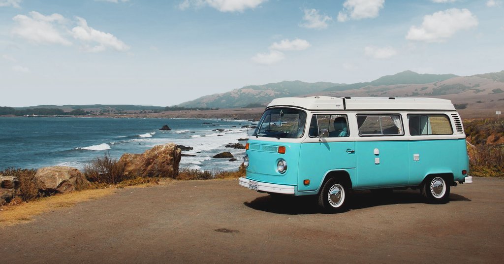 Campervan parked in scenic countryside, ready for a UK camping holiday.