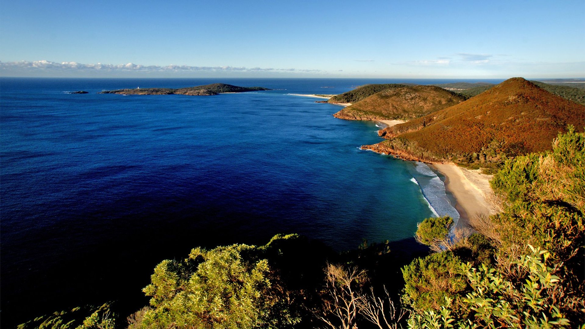 Campervan overlooking turquoise bay in Port Stephens. Adventure awaits!