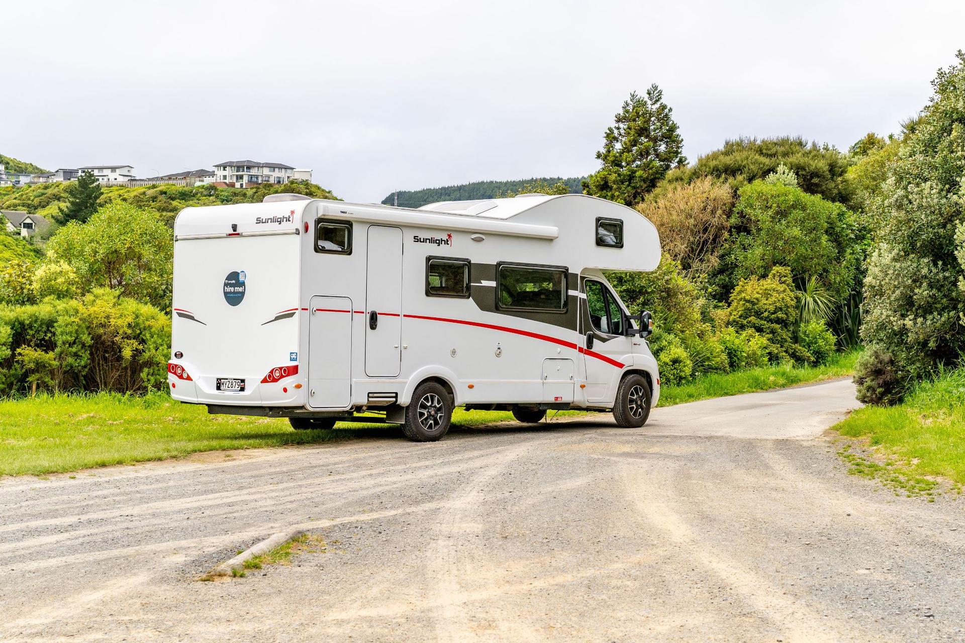Campervan parked up in a scenic NZ spot, ready for freedom camping.