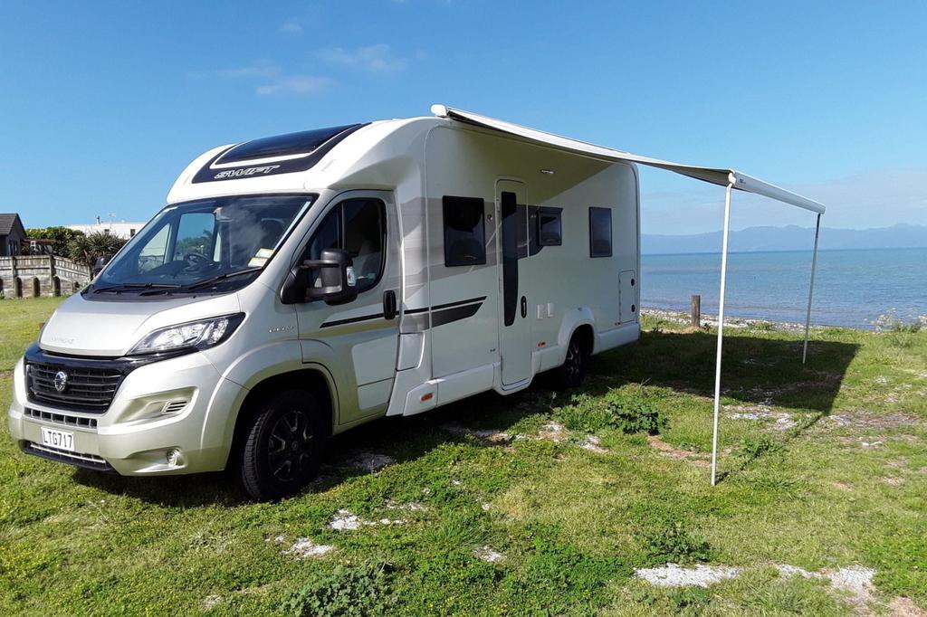 Motorhome parked up at a scenic Kiwi campground, ready for adventure.