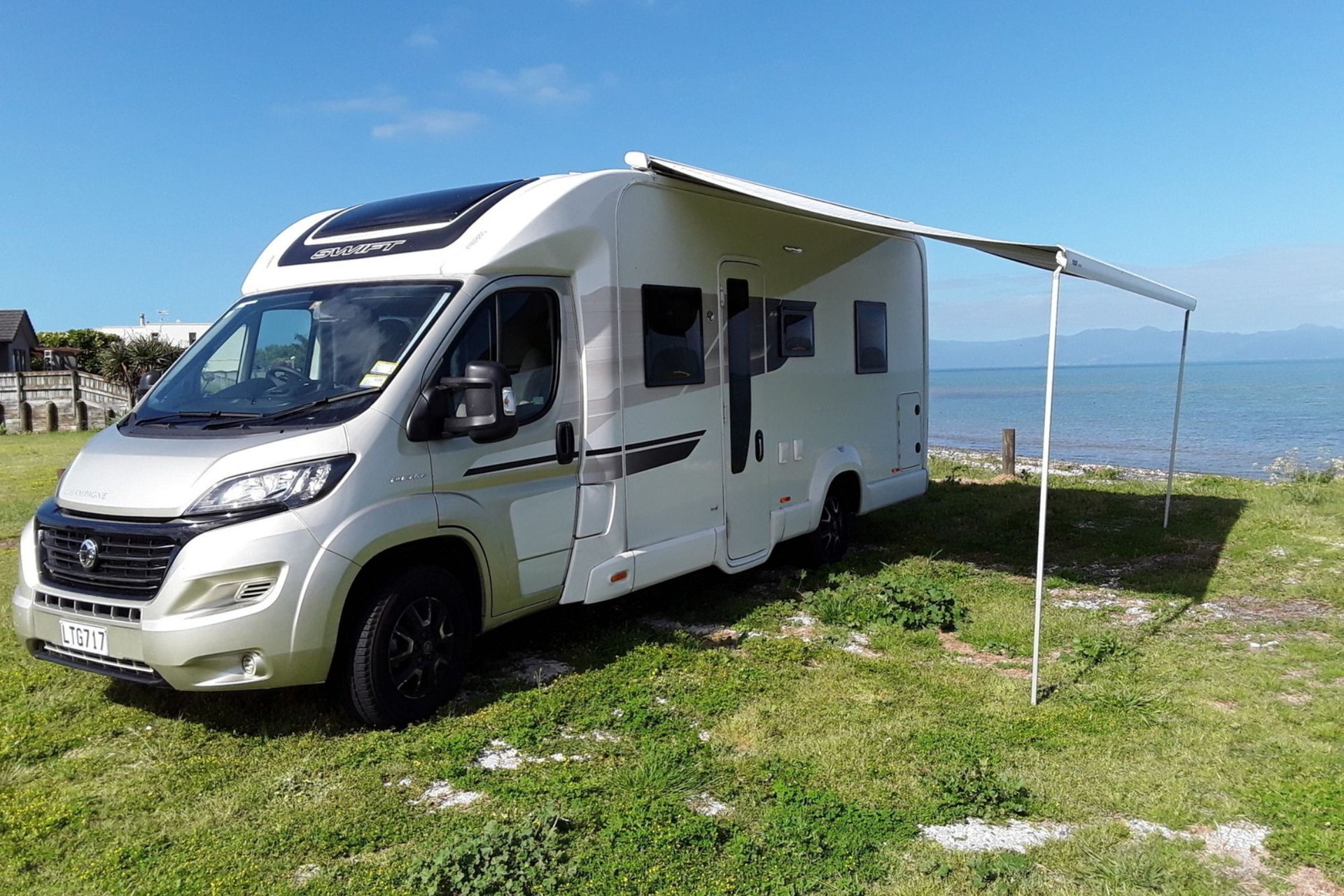 Motorhome parked up at a scenic Kiwi campground, ready for adventure.