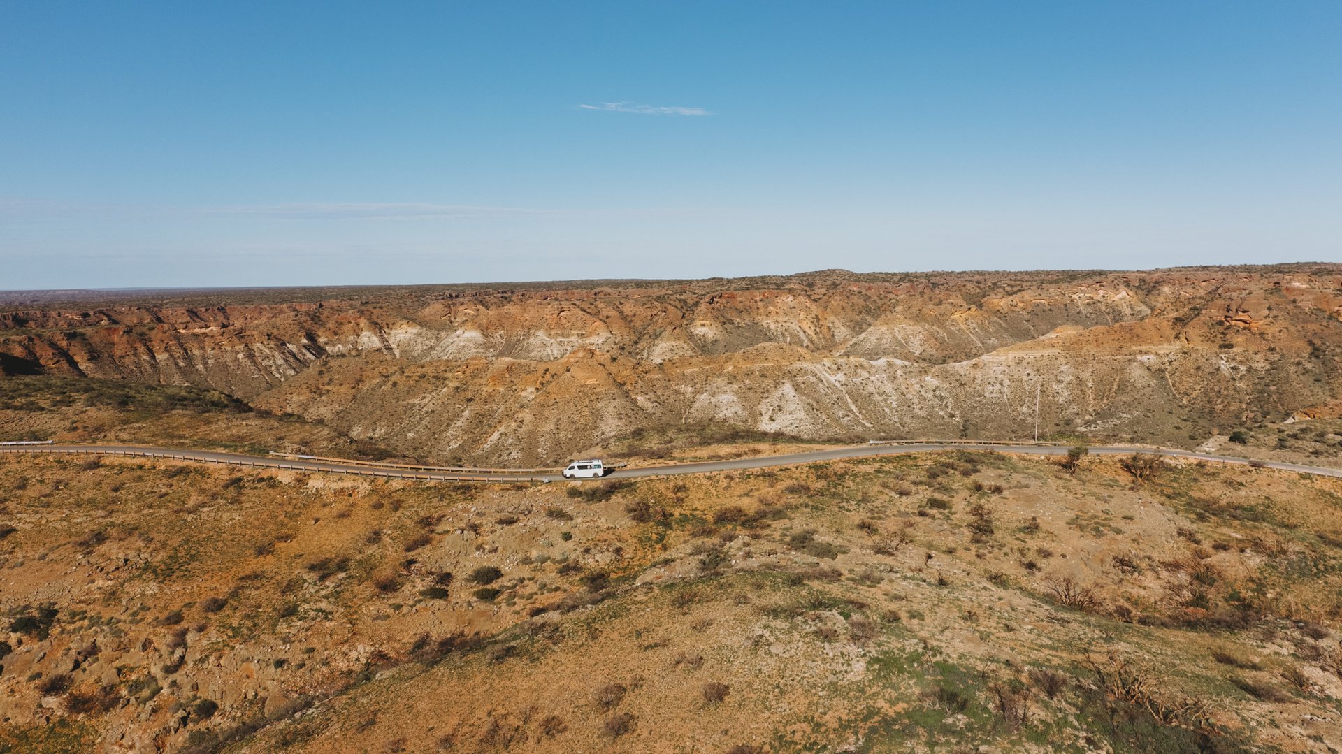 a Camplify campervan driving through Western Australia's mountain ranges