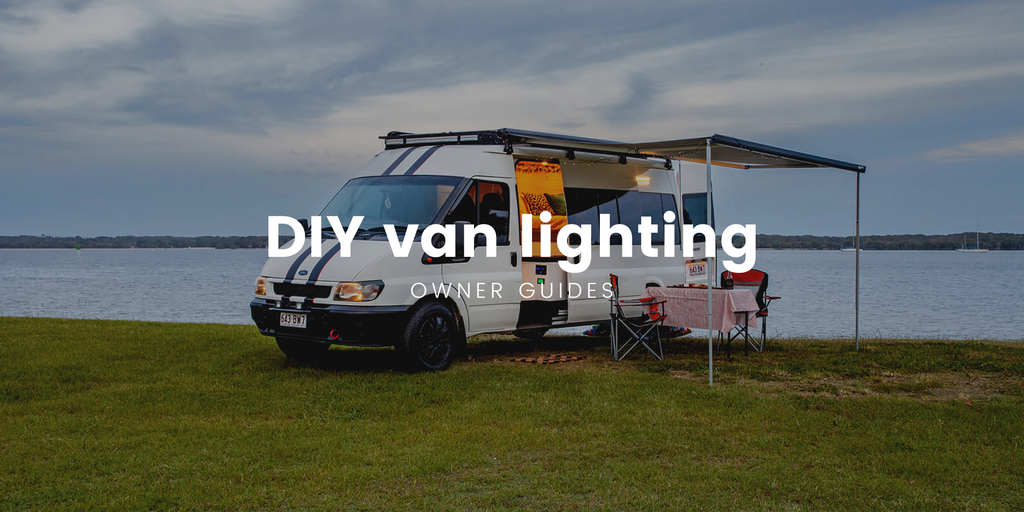Campervan interior, warm lighting, showcasing a comfy DIY van conversion setup.