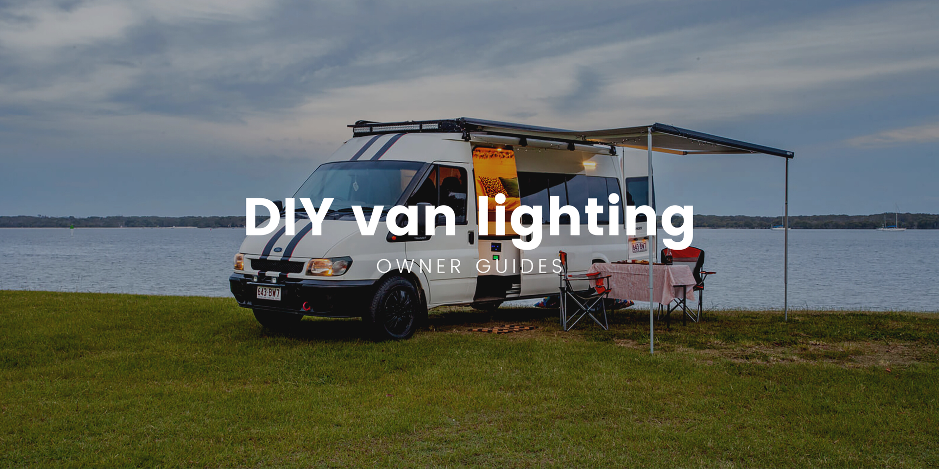 Campervan interior, warm lighting, showcasing a comfy DIY van conversion setup.