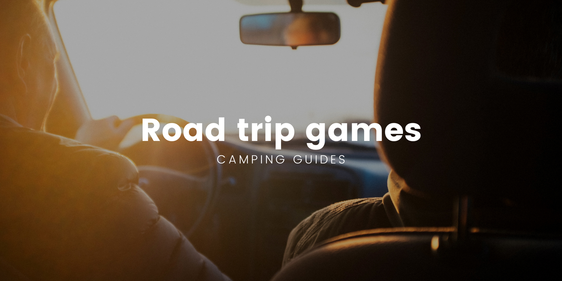 Couple playing travel games in a campervan, enjoying a roadie in the great outdoors.