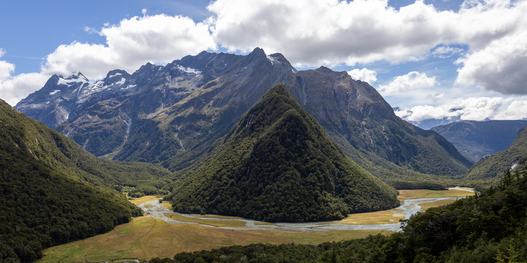 Routeburn Track: Tramper gazes over alpine vista on a trek in Aotearoa New Zealand.