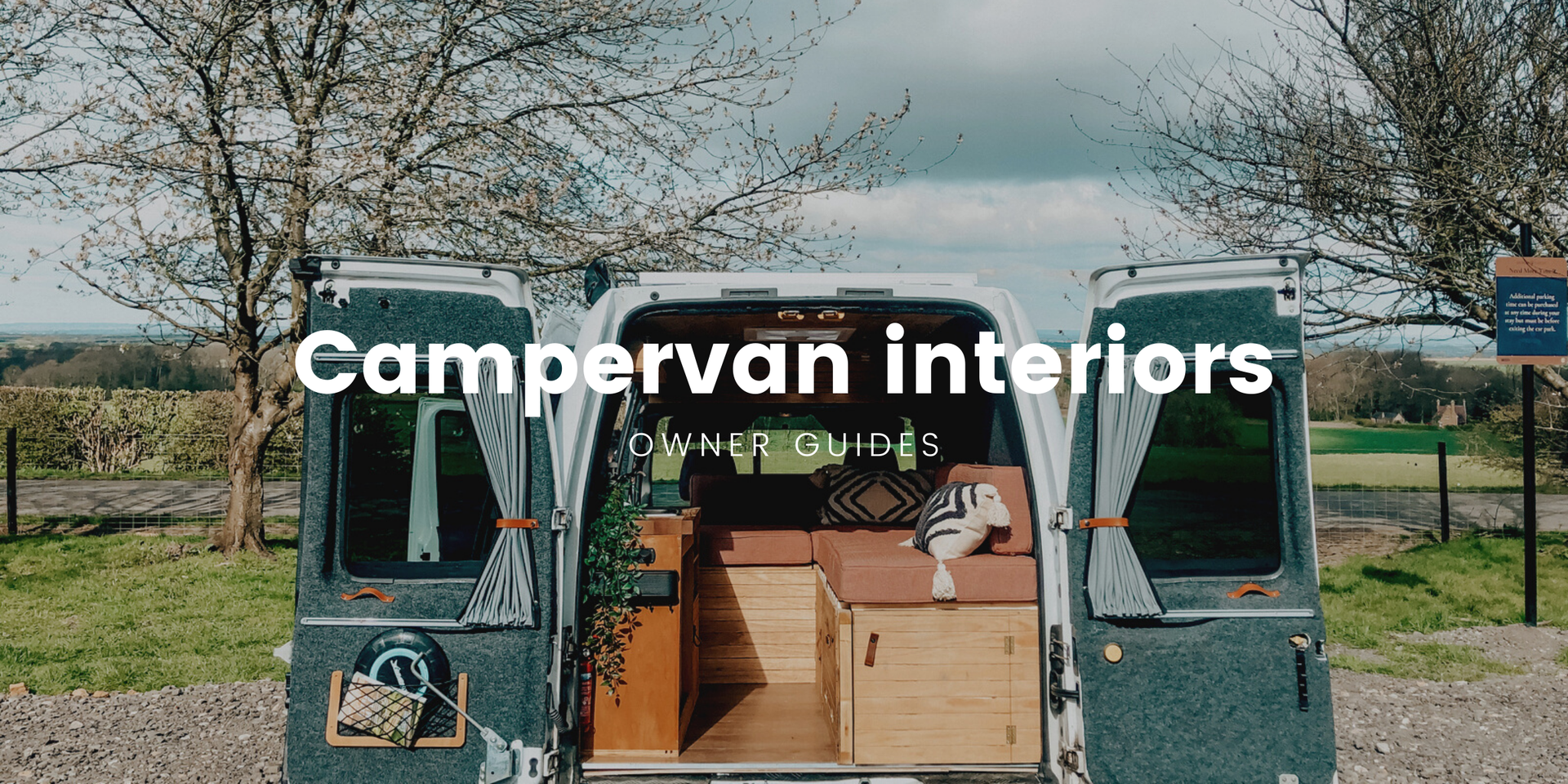 Campervan interior with fairy lights, parked near scenic loch. Cosy travel vibe.