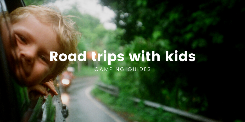 Kids waving from the back seat of a station wagon, heading off on a Kiwi roadie.