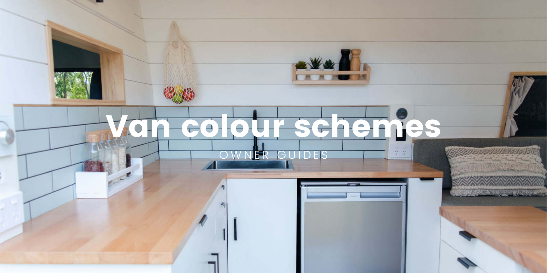 Campervan interior with timber panelling, parked at a stunning coastal campground.