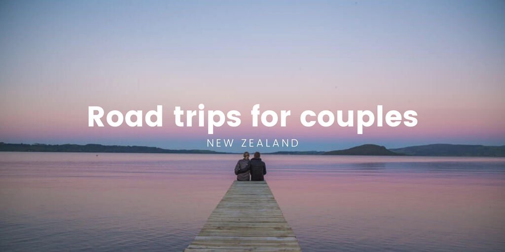 Couple in campervan, gazing at a scenic South Island vista. Road trip romance!