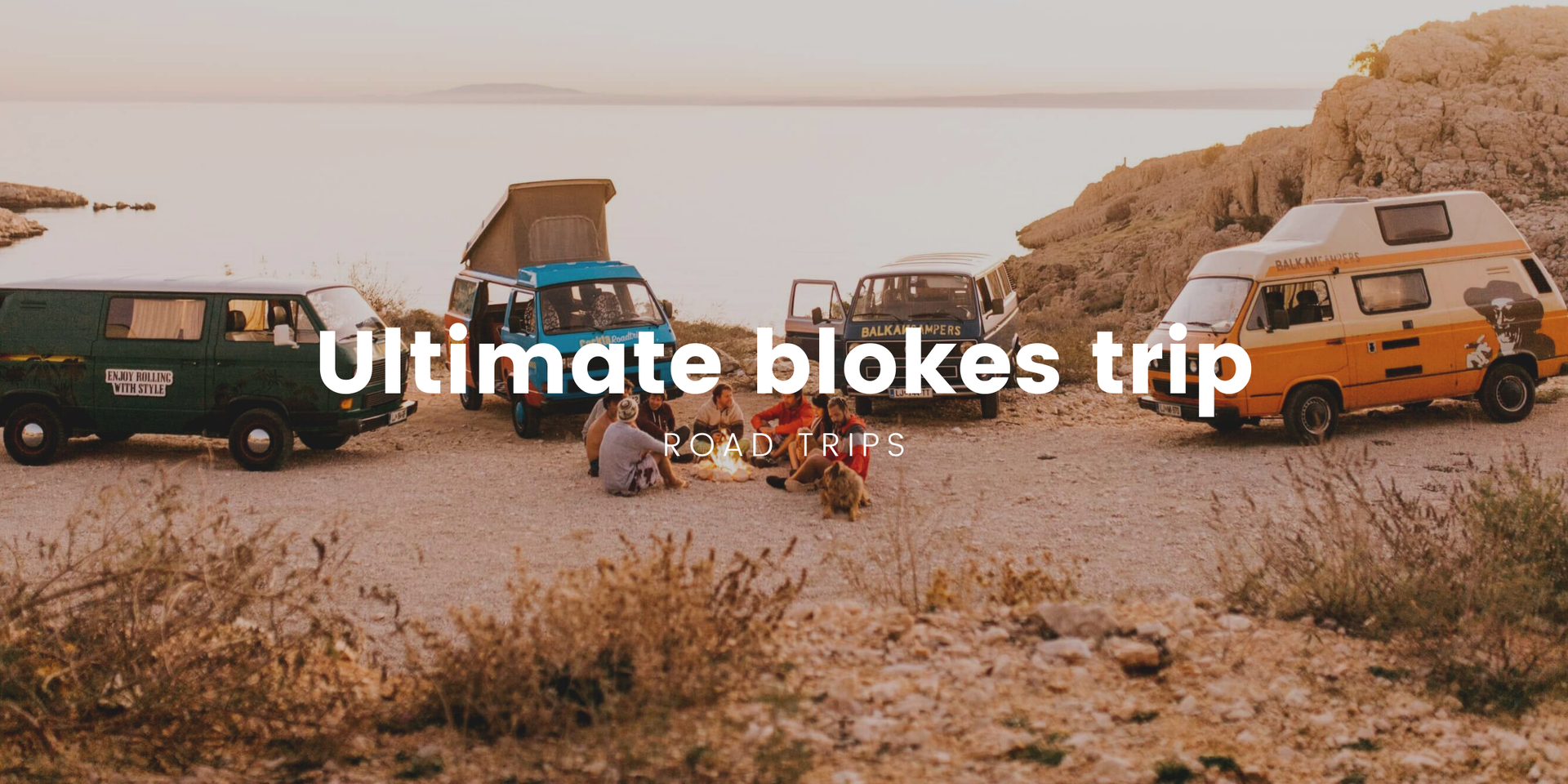 Lads on a camping trip, beers in hand, enjoying a coastal view in their 4WD.