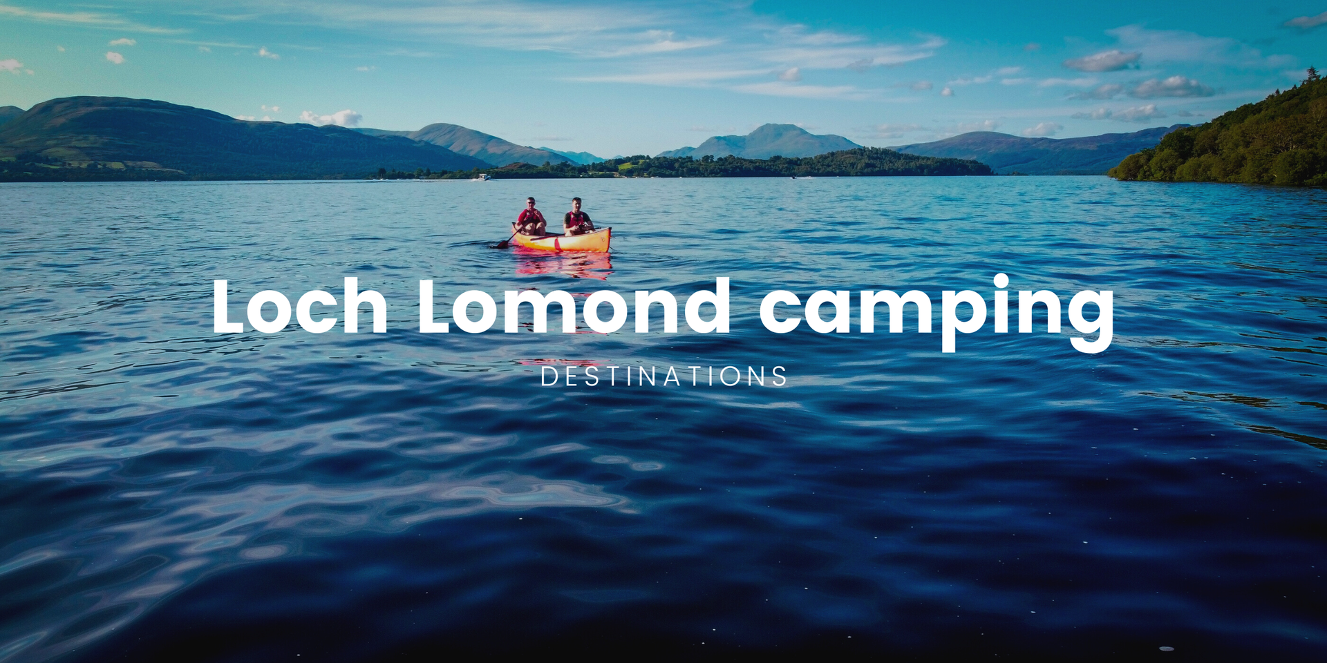 Tents pitched at Loch Lomond campsite, surrounded by trees with the loch in the distance.