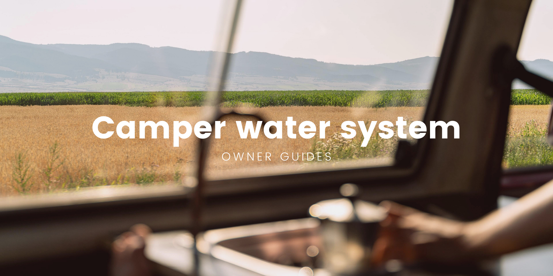 Campervan parked by a tranquil loch, ready for adventure with its DIY water system.